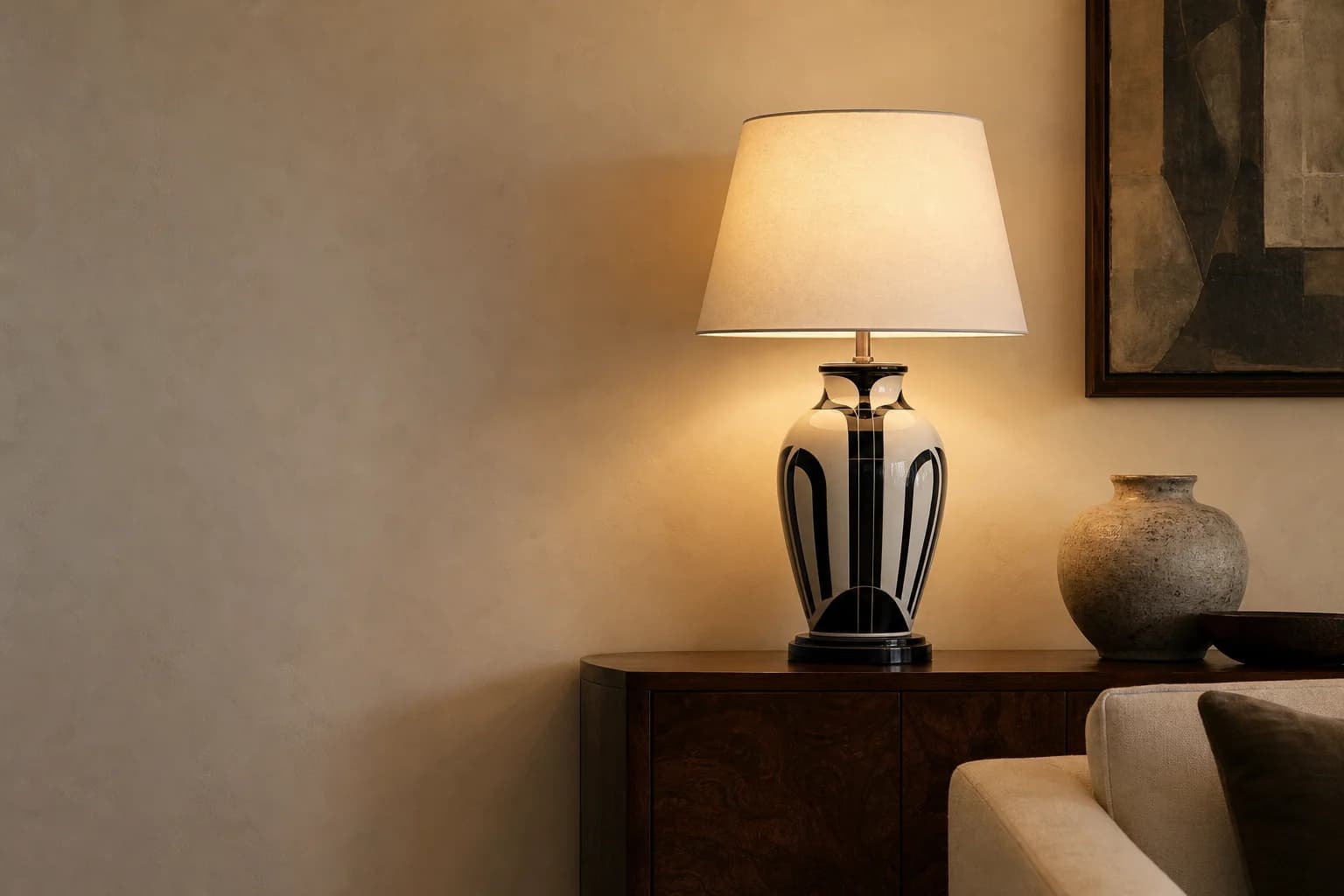Art deco ceramic table lamp glowing in a warm living room